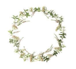 Fototapeta premium Wreath frame with pink flowers, heath, branches and leaves on white background. Flat lay style. Overhead view. Copy space.