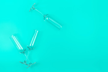 Three champagne glasses on trendy mint background with place for text. Holiday concept. Mockup for your design. Flat lay style.