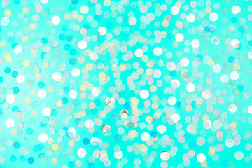 Festive background with round paper confetti in trendy mint color. Copy space. Holiday concept.