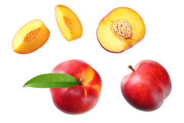 Nectarine with green leaf and slices isolated on white background. top view