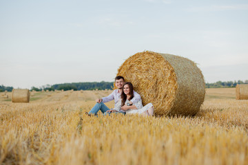 Naklejka na ściany i meble Happy young couple on straw, romantic people concept, beautiful landscape, summer season