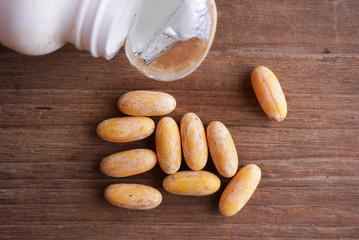 Expired supplements on wood background