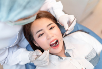 Closeup woman having dental teeth examined dentist check-up via excavator in Clinic her patient for...