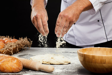 Close up of unrecognizable baker sprinkling flour over puffy batter while making traditional bread, copy space