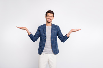 Portrait of his he nice attractive stylish cheerful cheery businessman agent broker wearing checked blazer holding invisible objects on palms isolated over light white pastel background