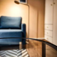 Glass coffee table of free space for your product and blurred home interior of autumn time. 