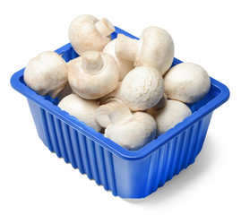 Fresh champignons in plastic packaging isolated on white background. Top side view. Clipping path.