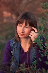 Woman in purple on nature portrait