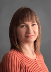 Portrait woman in orange sweater on the gray background