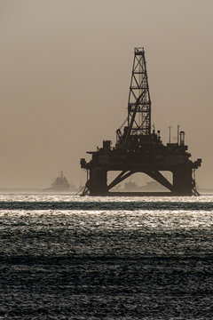 Oil platform installed in the sea in contrasting light.