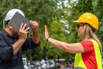Conflict and disagreement at work on construction site. Angry construction boss yelling at an...