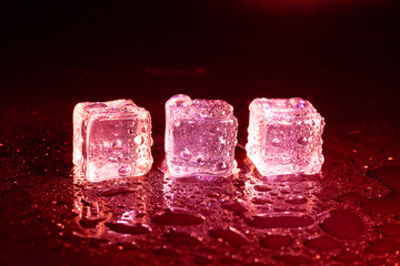 ice cubes on a reflections red light.