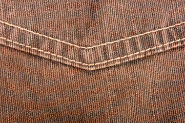 clothing items stonewashed cotton fabric texture with seams, clasps, buttons and rivets, macro