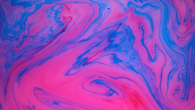 Stains of blue and pink ink on the water. Abstract colored background footage, fluid design.