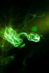 Fototapeta premium Green smoke motion on black background.