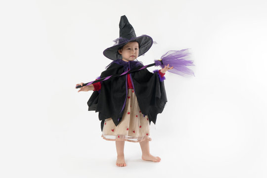 Halloween cute girl wearing witch costume in white background