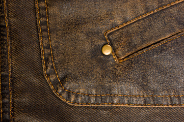 clothing items stonewashed cotton fabric texture with seams, clasps, buttons and rivets, macro