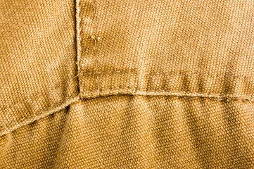 clothing items stonewashed cotton fabric texture with seams, clasps, buttons and rivets, macro