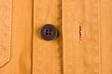 clothing items stonewashed cotton fabric texture with seams, clasps, buttons and rivets, macro