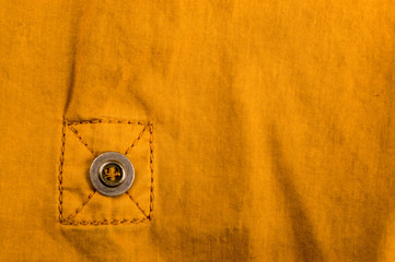 clothing items stonewashed cotton fabric texture with seams, clasps, buttons and rivets, macro