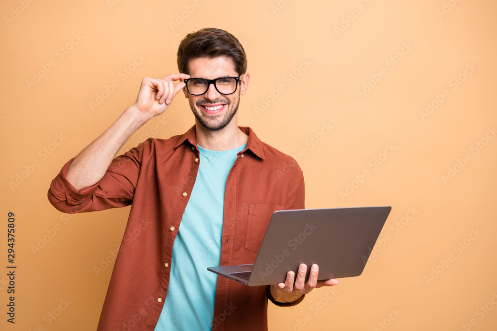 Poster portrait of his he nice attractive cheerful cheery successful content brunette guy holding in hands 