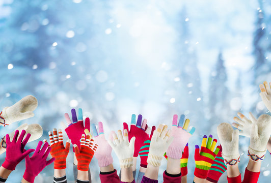children hands with winter gloves and mittens, christmas background