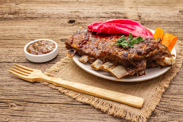 BBQ pork ribs with fermented cabbage, baked carrot, fresh parsley