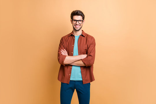 Portrait of his he nice attractive content successful cheerful cheery brunet guy company director owner folded arms isolated over beige color pastel background