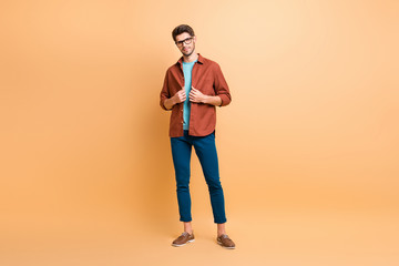Fototapeta na wymiar Full length body size view of his he nice attractive lovely fashionable brunet guy dandy fixing clothing shirt posing new cool modern look isolated over beige color pastel background