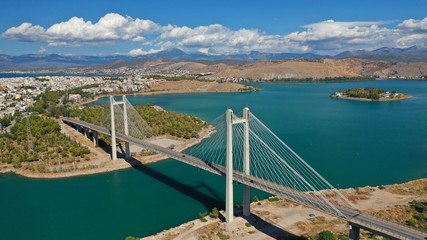Obraz premium Aerial drone photo of famous new suspension bridge of halkida or Chalkida connecting mainland Greece with Evia island with beautiful clouds and blue sky, Greece