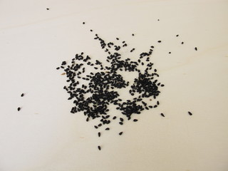 Black caraway seeds on a wooden board