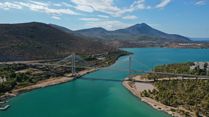 Aerial drone photo of famous new suspension bridge of halkida or Chalkida connecting mainland Greece with Evia island with beautiful clouds and blue sky, Greece
