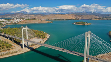 Aerial drone photo of famous new suspension bridge of halkida or Chalkida connecting mainland Greece with Evia island with beautiful clouds and blue sky, Greece