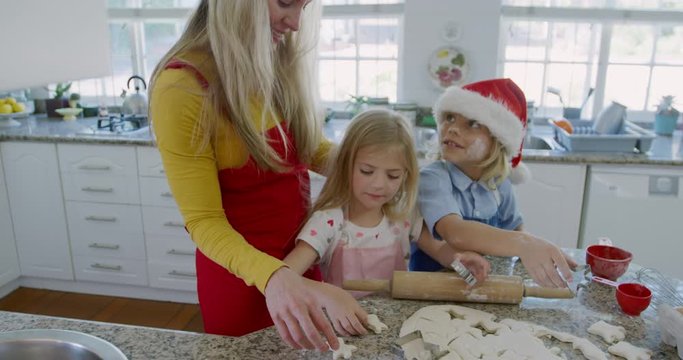 Siblings making christmas cookies at home