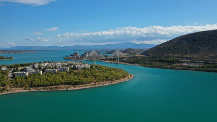 Fototapeta premium Aerial drone photo of famous new suspension bridge of halkida or Chalkida connecting mainland Greece with Evia island with beautiful clouds and blue sky, Greece