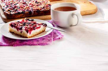 Tasty breakfast. Delicious pie with berries and cottage cheese an a cup of tea
