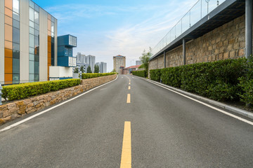 Fototapeta na wymiar empty highway with cityscape and skyline of qingdao,China.