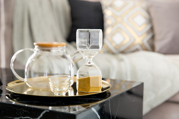 Stylish scandinavian composition of marble console with jar tea and accessories.