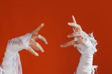 Halloween, costume image. The mummy's hand in bandages making gestures