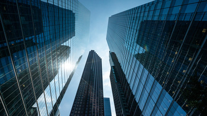 Fototapeta na wymiar Office buildings with blue sky with sun reflection