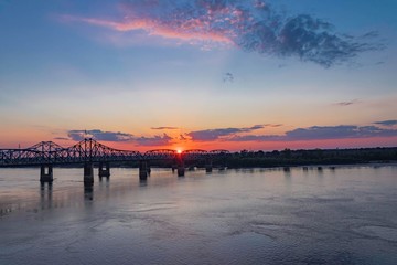 Naklejka na ściany i meble Orange sunset over the Mississippi river 