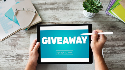 Giveaway, enter to win text on screen. Lottery and prizes. Social media marketing and advertising concept.