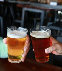 glasses of beer with foam In restaurant background