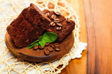 Brownie cake with coffee beans and mint leaves