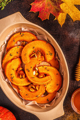 Baked slices of pumpkin on a dark background.