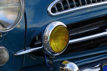 Fototapeta na wymiar classic car headlamp and grill detail