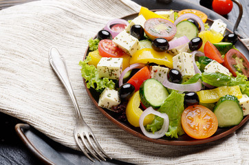 Fototapeta na wymiar Mediterranean diet dish greek salad on vintage metal tray closeup photo
