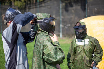 The masked man. Sports mask for playing paintball on the player’s head. Black mask with safety glass. Protection for the whole face from bullets with paint.