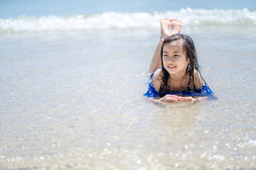 Children playing sand in summer on the beach