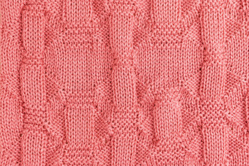 Pink knitted soft blanket. Knitted pink background. Top view.